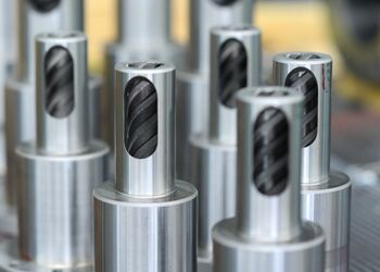 Several helical grooved bushings are made ready for packaging